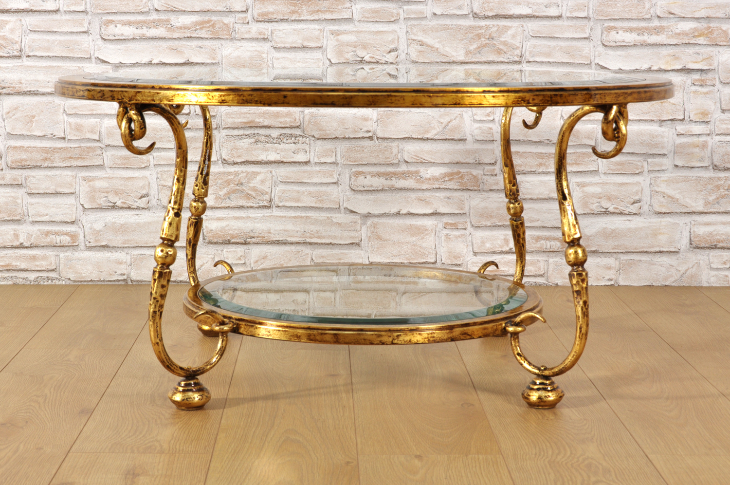 tavolo rotondo circolare di lusso in ferro battuto con piani in cristallo molato dorato in foglia oro patinato manufatto di lusso di costruzione made in Italy esclusivo